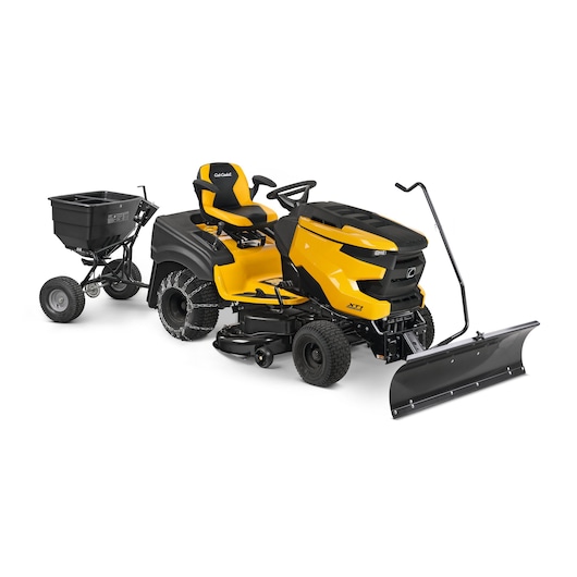 CubCadet 13A8A1TB603 riding lawn mower side angle with plow and rear tow spreader attachment on white background.