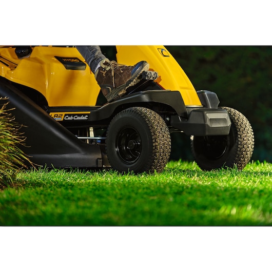CubCadet 13AB21HD603 lawn tractor side view showing front wheels and person’s boot on pedal