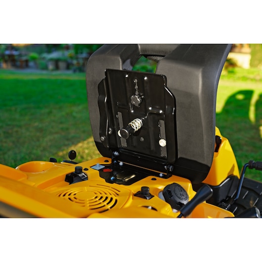 CubCadet 13AB21HD603 lawn tractor seat underside showing spring mechanism, outdoor angle.