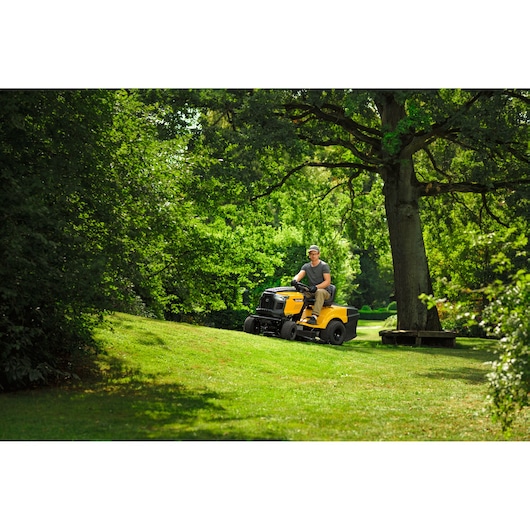 CubCadet LT3-PR105 SKU 13AJ71BN603 riding lawn mower on grassy hillside, outdoor setting.