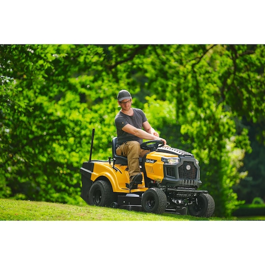 Photo of CubCadet LT3-PR105 SKU 13AJ71BN603 yellow lawn tractor in use outdoors on grass