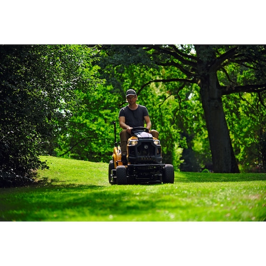 CubCadet LT3-PR105 SKU 13AJ71BN603 lawn tractor mowing grass in a garden, front angle photography.