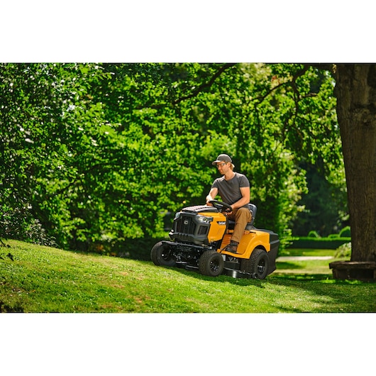 CubCadet LT3-PR105 SKU 13AJ71BN603 lawn tractor mowing grass on a sunny lawn.