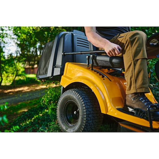 CubCadet 13AJ71BN603 LT3-PR105 lawn tractor side view outdoors with operator seated.