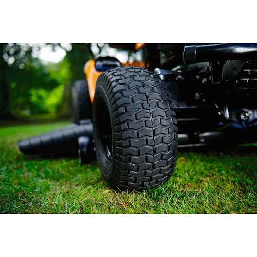 CubCadet LT3-PR105 13AJ71BN603 riding mower close-up of rugged rear tire on grass, outdoor photography.