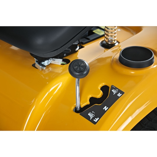 CubCadet LT3-PS107 13AY78BS603 lawn tractor gear shift close-up on yellow body, seat and cup holder visible.