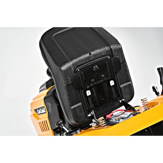 CubCadet LT3-PS107 lawn tractor seat lifted up showing springs and wiring, close-up, SKU 13AY78BS603, side angle.