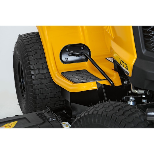 CubCadet LT3-PS107 13AY78BS603 lawn tractor side step and lever, close-up on yellow body.