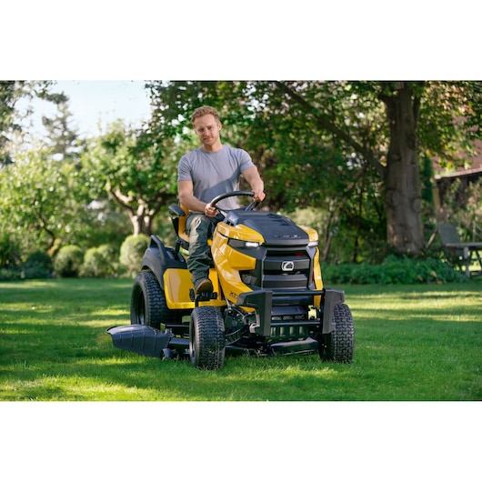 Photo of CubCadet 14AFA5TQ603 riding lawn mower in use on grass, front angle view.