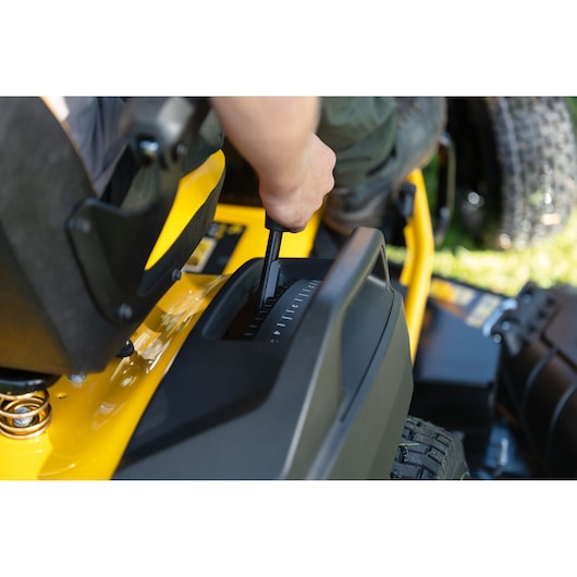 CubCadet 14AFA5TQ603 lawn mower control lever photography showing operator hand close-up.
