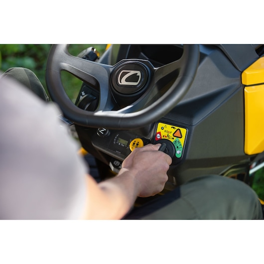 CubCadet 14AFA5TQ603 lawn tractor control panel close-up with user hand on ignition.