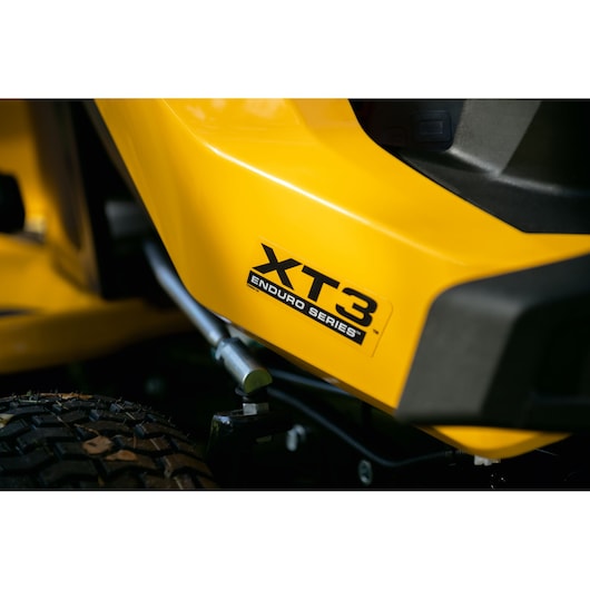 Close-up photo of CubCadet 14AFA5TQ603 XT3 Enduro Series lawn tractor yellow body and tire.
