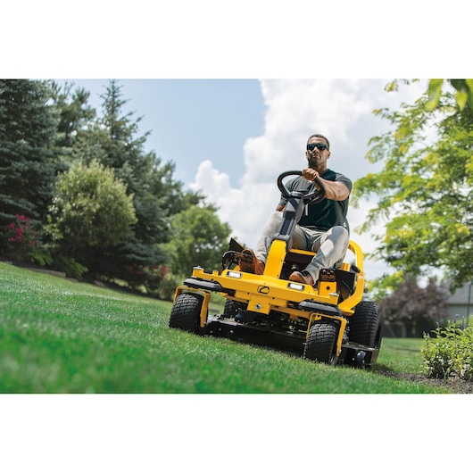 CubCadet 17AIGGY2603 yellow riding lawn mower on grass, front angle outdoors.