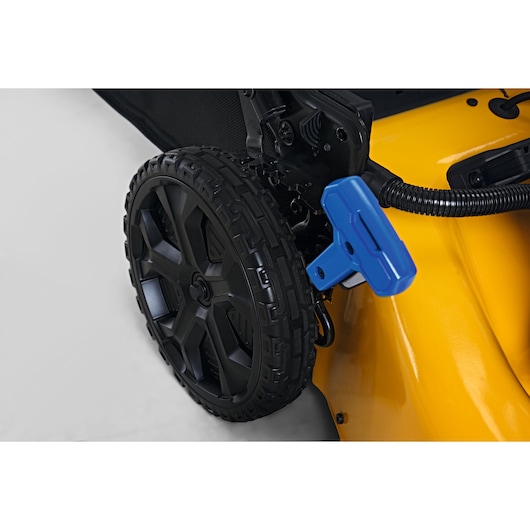 CubCadet 18ASTR94603 lawn mower rear wheel close-up with blue adjustment lever, photographed on white.