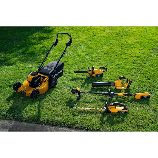 CubCadet 18ASTR94603 lawn care tool set includes mower, blower, trimmer, hedge cutter, on grass, outdoor angle.