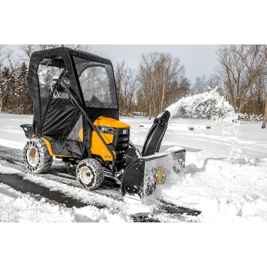 CubCadet 19A40024100 snow blower tractor clearing snow, side angle, yellow body, black cab, winter scene.