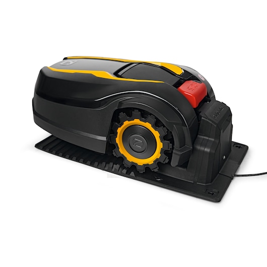 CubCadet 22AKFEFA603 robotic lawn mower with yellow and black body, side angle on charging station.