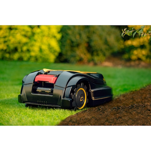 CubCadet 22AKHEFA603 robot lawn mower on grass, side angle, black and yellow design.