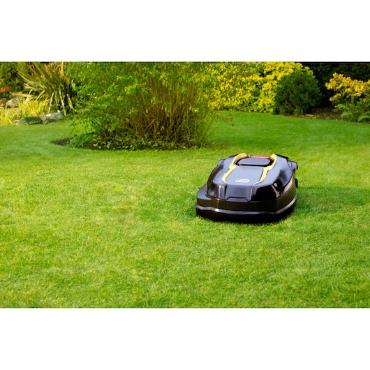 CubCadet 22AKHEFA603 robotic lawn mower on grass, black with yellow accents, taken outdoors.