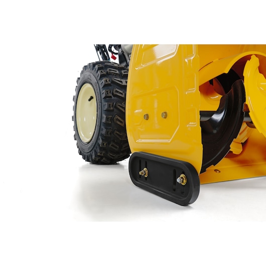 CubCadet 31AY5EVX603 snow blower close-up, showing yellow housing and wheel, angled on white background.