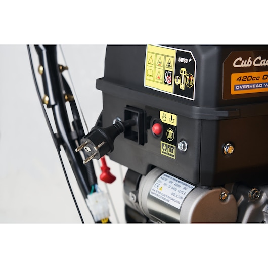 CubCadet 31AY5EVX603 snow blower engine close-up with power cord plugged in and warning labels.