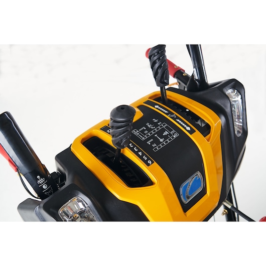 CubCadet 31AY5EVX603 snow blower control panel close-up, yellow and black with gear levers.