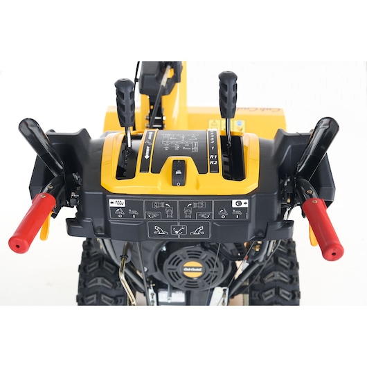 CubCadet 31AY5EVX603 snow blower control panel with levers and red handle grips, top view, white background.