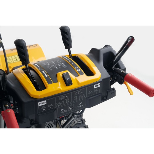 CubCadet 31AY5EVX603 snow blower control panel with black and yellow levers, close-up on white background.