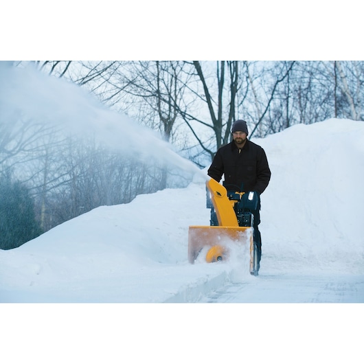 CubCadet 31AY5EVY603 snow blower clearing snow, front view, outdoor winter scene.