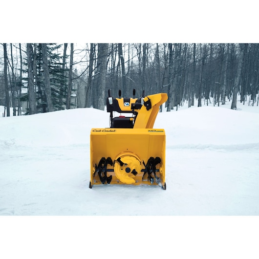 Photo of CubCadet 31AY5EVZ603 yellow snow blower, front view, on snowy outdoor background.