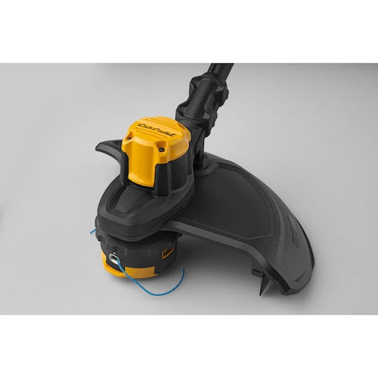 CubCadet 41AT6TGT603 string trimmer close-up, showing yellow and black head and guard on white background.