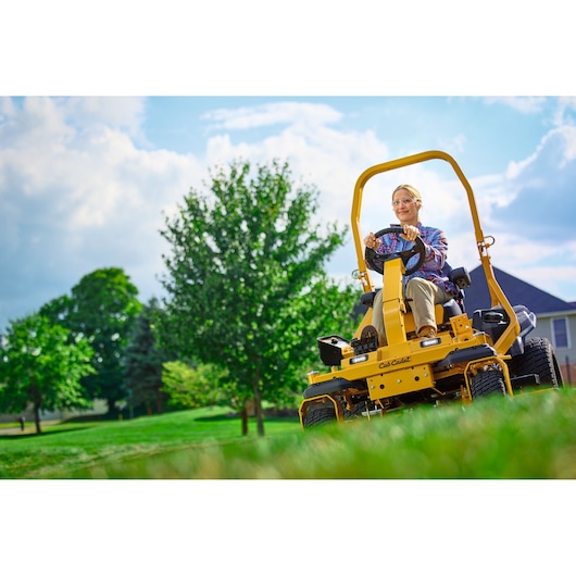 CubCadet 47AICAB6603 yellow riding mower on grass lawn, front angle, outdoors, clear sky background.