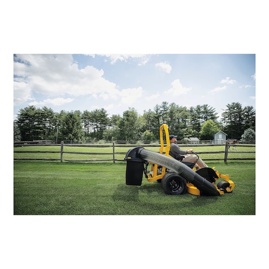 Photo of CubCadet XZ7-L152i-ULTIMA 47ATAHA8603 zero-turn mower in use on green lawn, side view.