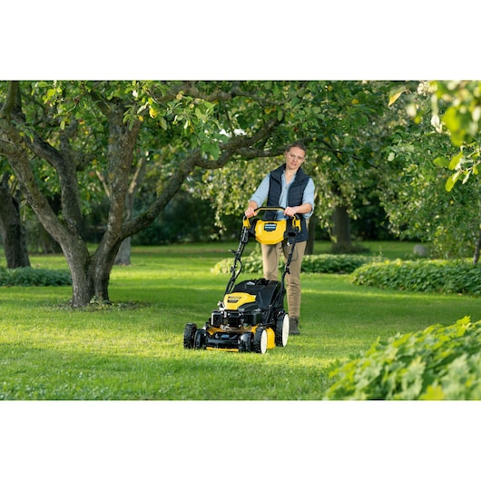Woman pushing a Cub Cadet LM3 lawn mower